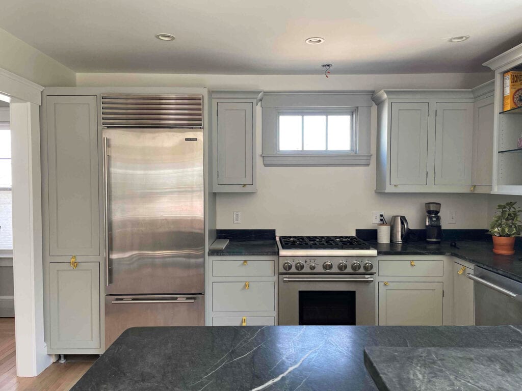 Soapstone kitchen countertops, gray painted cabinets and trim, Benjamin Moore Dove Wing walls, stainless steel appliances.