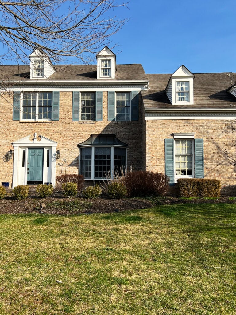 benjamin moore hamilton blue on front door AND SHUTTERS with brick house, beige PINK PEACH, brown brick. Colonial style exterior. (2) - Copy