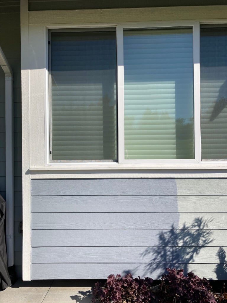 sample of light to medium toned blue gray exterior, Sherwin Williams Cadet with Alabaster warm white trim and white windows, on Unusual gray