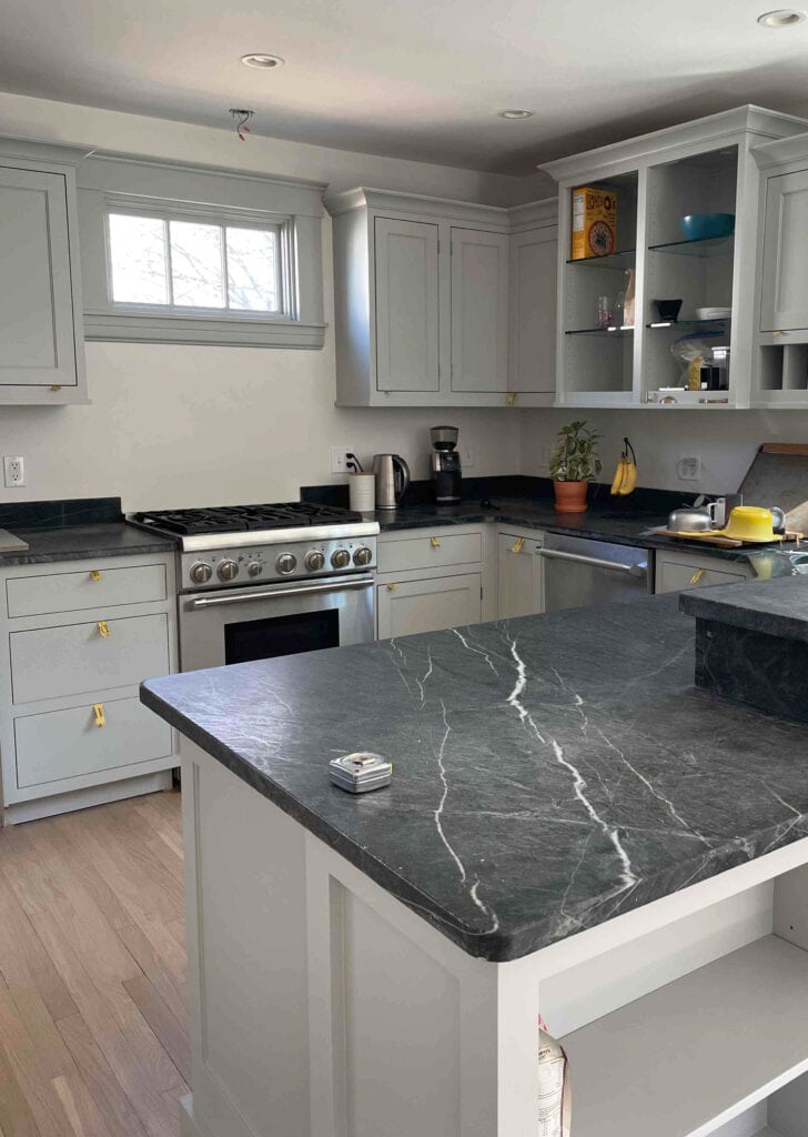 soapstone countertops, dark black gray, red oak floor, gray painted cabinets and trim, Dove Wing paint color on walls