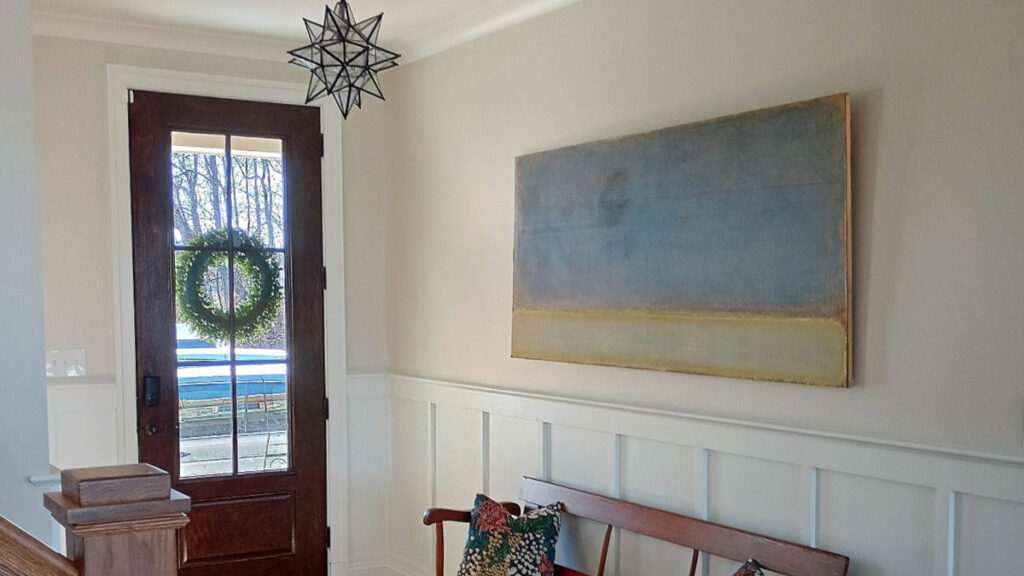 BENJAMIN MOORE WIND'S BREATH IN AN ENTRYWAY WITH WHITE WAINSCOTING (PURE WHITE) AND WOOD FLOORING