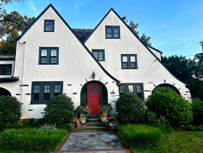 Benjamin Moore Caliente best red front door paiont color, Tudor style exterior, warm white stucco Sherwin Williams Still Water trim