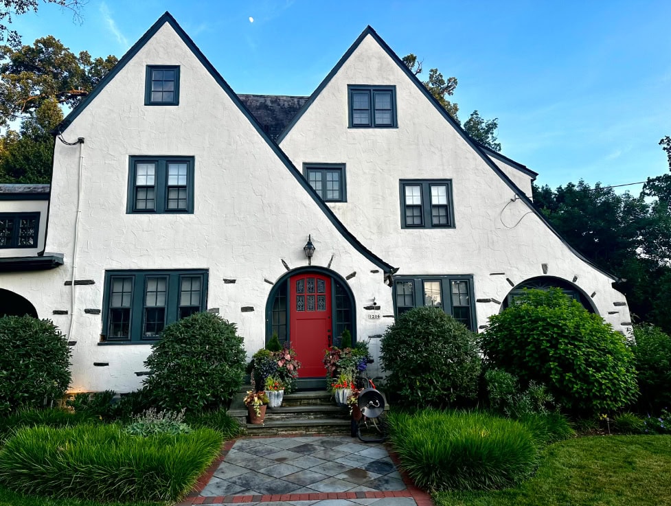 Benjamin Moore Caliente best red front door paiont color, Tudor style exterior, warm white stucco Sherwin Williams Still Water trim