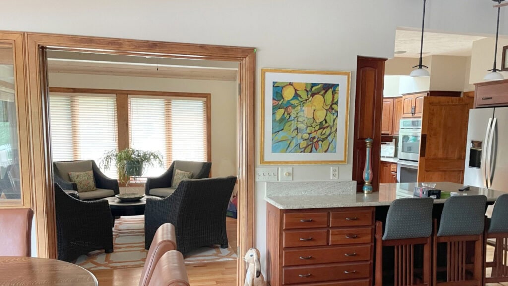 Benjamin Moore Muslin with wood trims and cherry wood cabinets. Sun room with rattan chairs