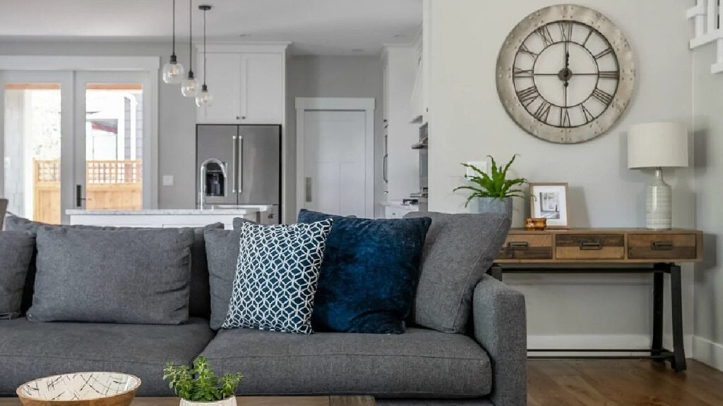 Benjamin Moore Stonington Gray walls, north-facing light with dark gray sectional