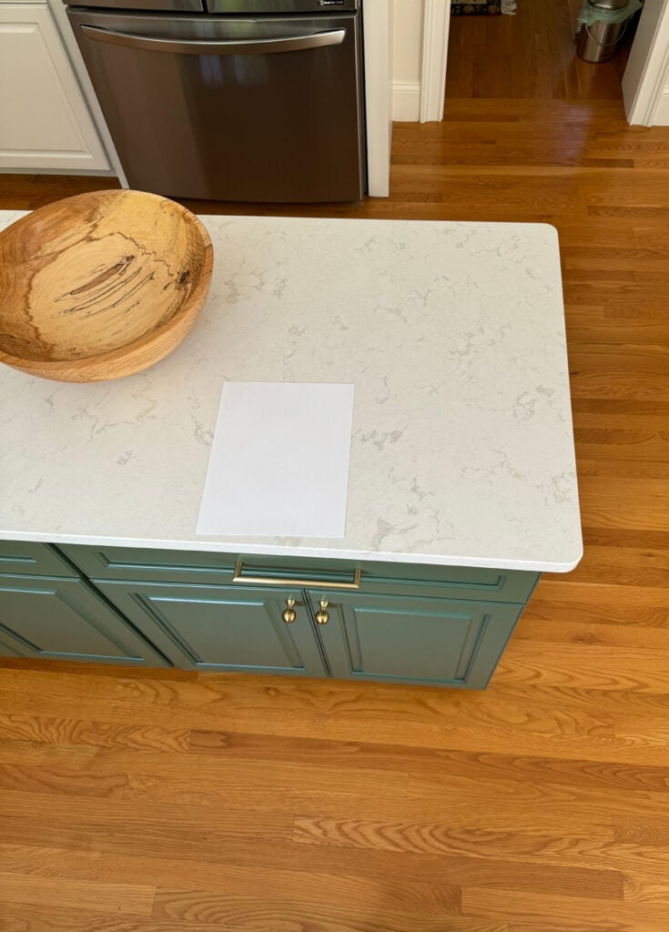 Cambria Torquay white quartz countertop, golden oak floor, Peale Green BEnjamin Moore painted island cabinet