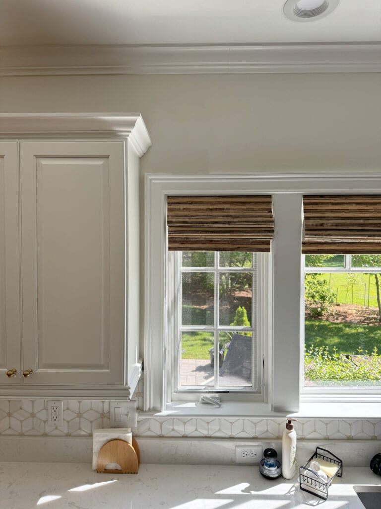 Sherwin Williams Pearly White off white walls, White Dove Benjamin MOore painted kitchen cabinets, bamboo blinds.