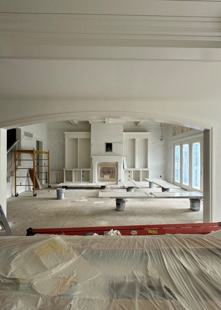 living room arched curved doorway opening, Sherwin Williams Alabaster warm white built in cabinets, fireplace surround