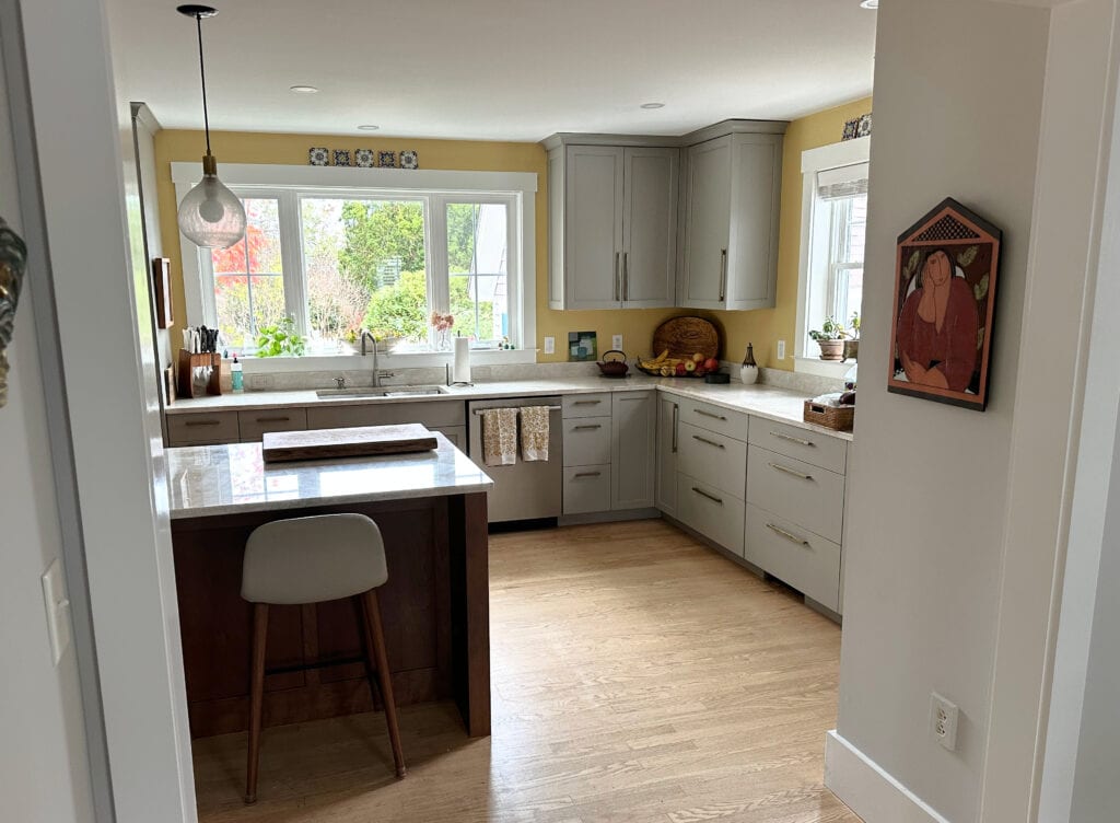 Benjamin Moore Da Vinci's Canvas yellow golden paint color on kitchen walls, Pavestone painted cabinets, Taj Mahal quartzite countertops, white oak flooring and wood island