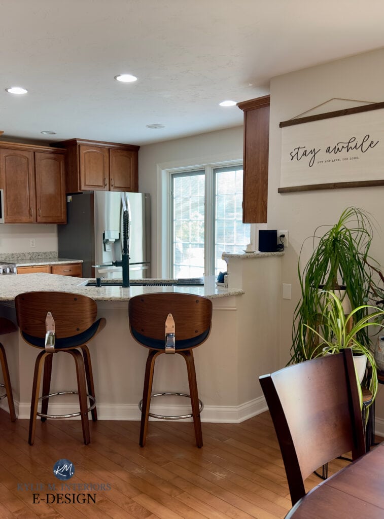 Sherwin Williams Egret White, taupe paint color, maple red pink toned wood floor, wood kitchen cabinets, counter stools
