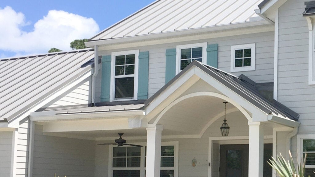 exterior paint color in BEnjamin MOore Gray Owl with light gray metal roof and blue-green shutters, white trim