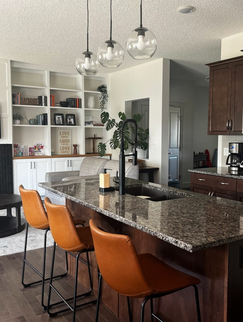 BENJAMIN MOORE EDGECOMB GRAY 75 lighter, Chantilly Lavce built-ins, black slate herringbone fireplace tile suround, dark wood cabinets, granite countertop