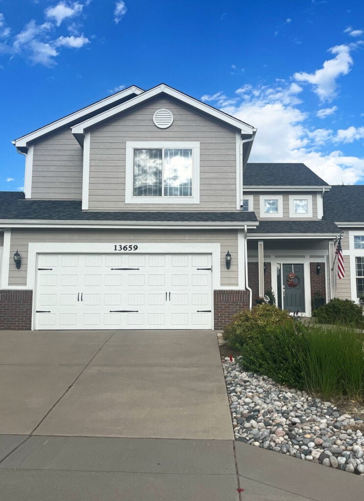 Beige taupe siding, Benjamin Moore Ashley Gray with white trim, Blue gray painted exterior front door, Ashland Slate. red and violet brick 