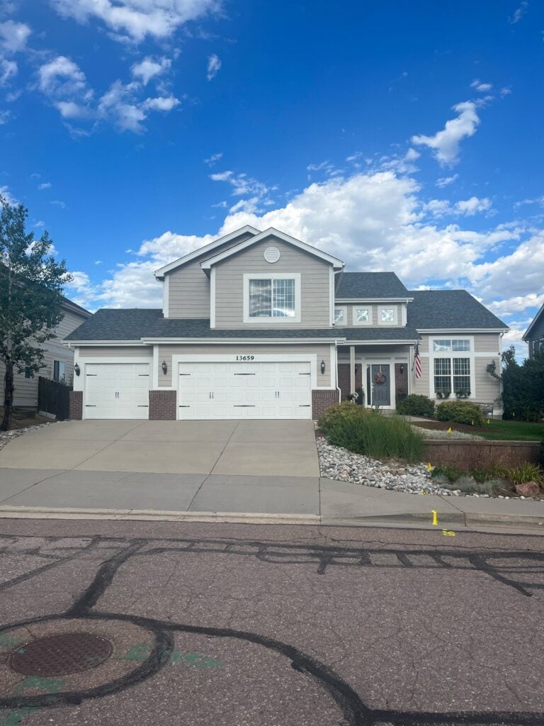 Beige taupe siding, white trim, Blue gray painted exterior front door, Ashland Slate. red and violet brick (1)