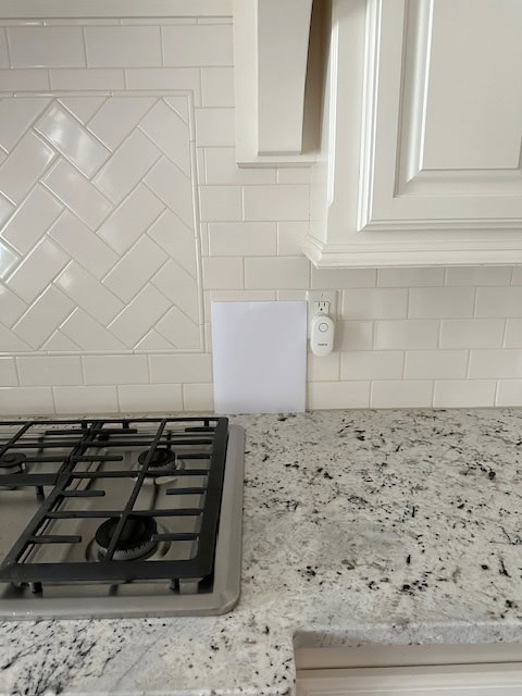 Kitchen wood cabinets painted a cream color with Creamy subway tile backsplash, granite countertop. Similar to Alaskan White or Colonial White, but not exact