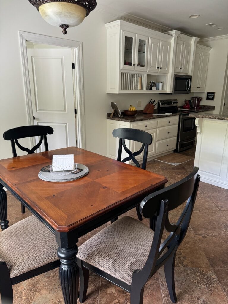 Sherwin Williams Dover White walls and painted cream warm white kitchen cabinets, laminate countertop, beige orange tile floor