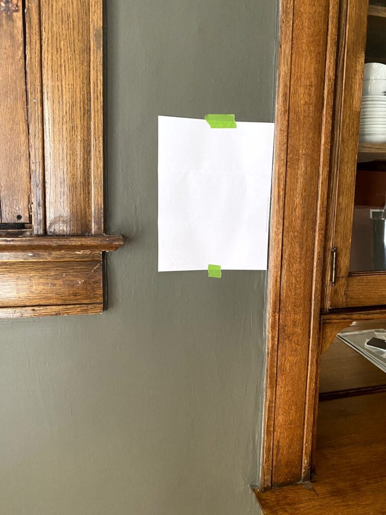 dark wood oak trim in old home with Benjamin Moore Castle Peak Gray, dark green greige on the walls