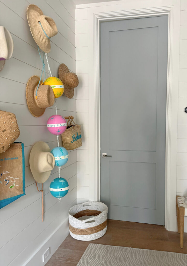 Bedroom interior door painted Benjamin Moore Woodlawn Blue (blue-gray), walls and trims Sherwin Williams Snowbound, warm white paint color. Beach home decor, LeMel Jewelry