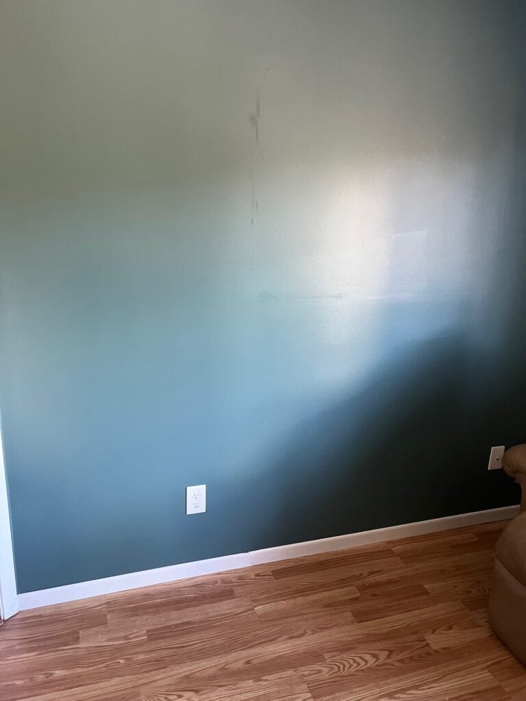 Benjamin Moore Caribbean Teal with pink red oak laminate floor and white trim, blue-green blend paint color