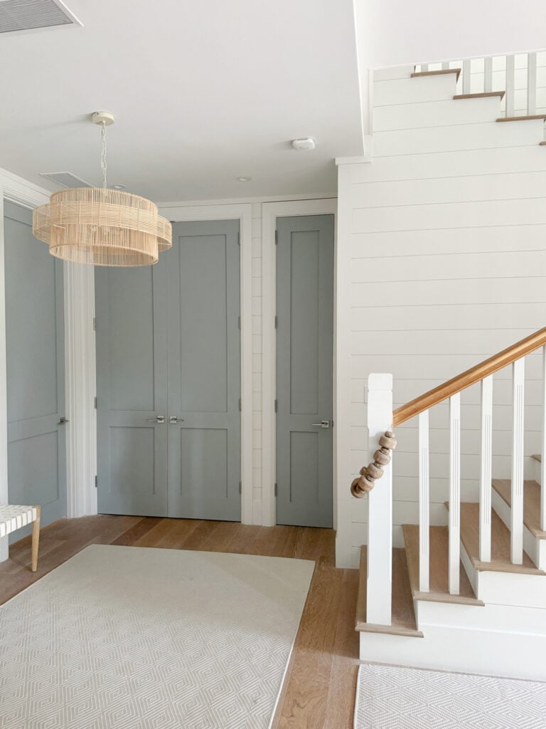 Shiplap accent wall, Sherwin Williams Snowbound on staircase, interior doors painted Benjamin Moore Boothbay Gray, Beach, coastal home of LeMel Jewelry owner