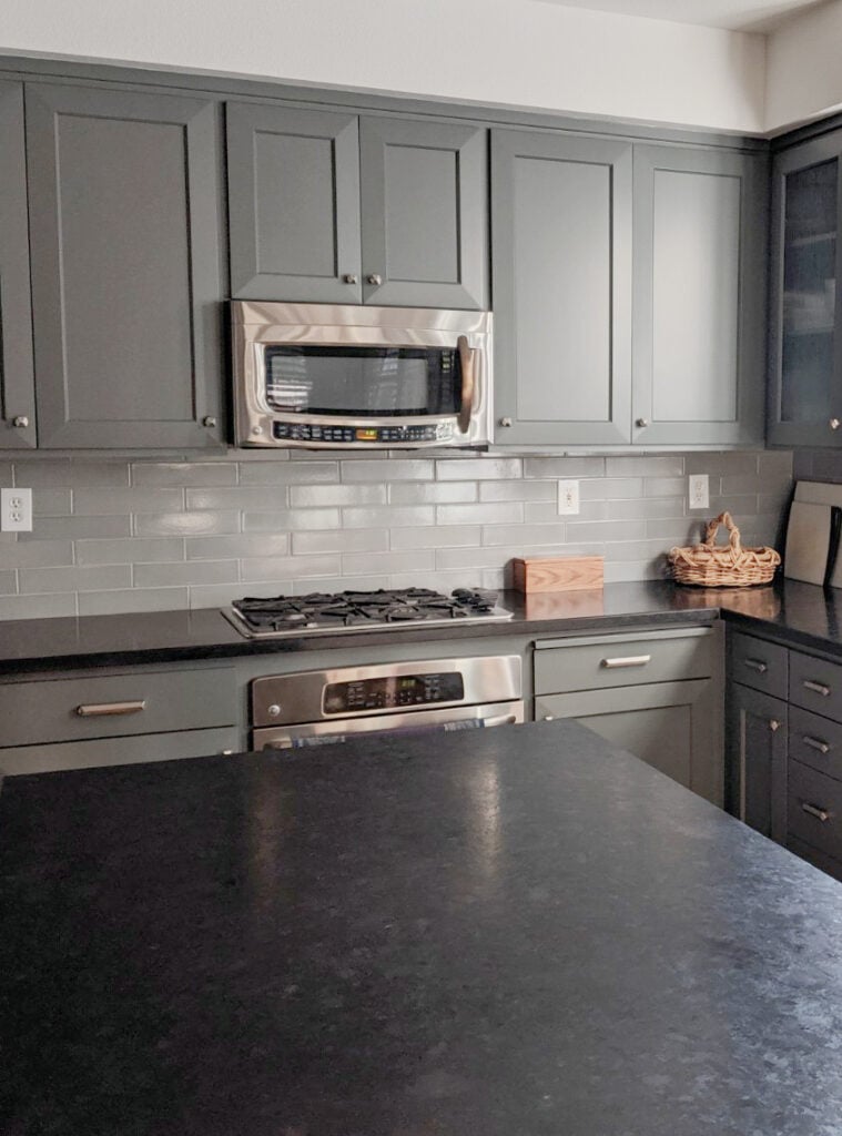 Benjamin Moore Kitty Gray lightened paintred kitchen cabinets, green-gray subway tile backsplash, honed black soapstone or granite countertops