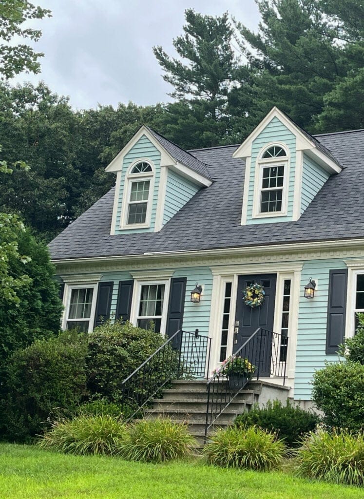 Benjamin Moore Palladian Blue exterior blue green siding color, Witching Hour door and shutters, Vanilla Ice Cream trim dormers. (1)