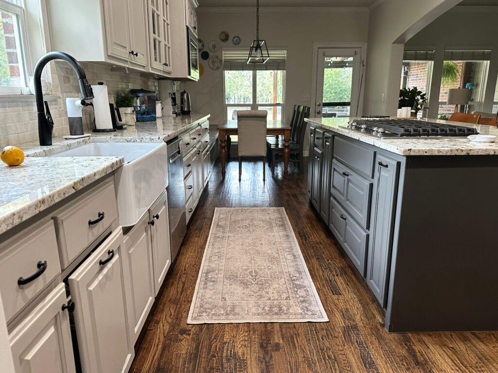 Benjamin Moore Pashmina greige painted wood kitchen cabinets, Sherwin Williams Urbane Bronze island, granite countertops