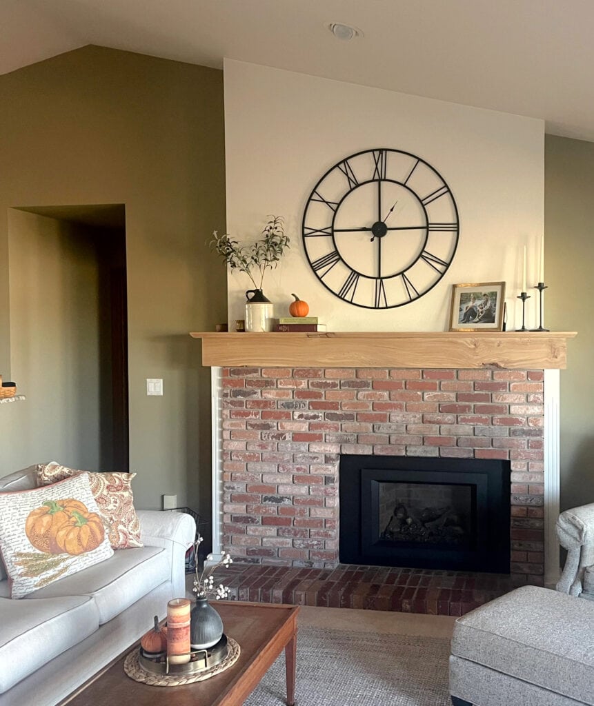 Benjamin Moore Providence Olive green paint color, fireplace color Sherwin Williams Greek Villa, pink and red brick fireplace, wood mantel, autumn home decor