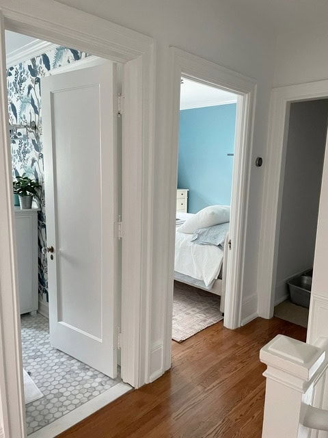 Benjamin Moore White Diamond in hallway on walls, trims, doors, ceiling, red oak flooring, marble tile in bathroom, blue bedroom