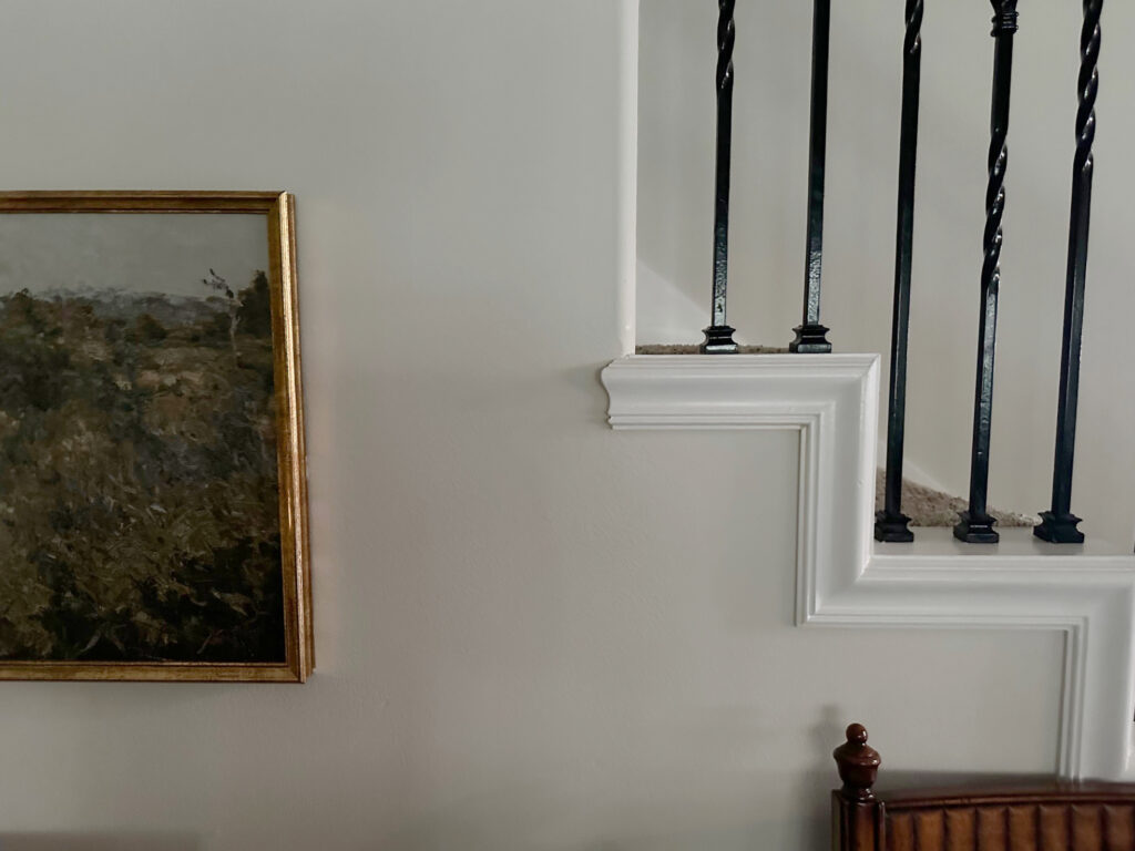 Benjamin Moore Winds Breath off-white paint color on walls, metal stair railing