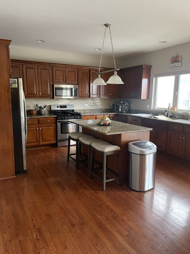 Cherry red maple cabinets with Santa Cecilia or Giallo granite countertop, red oak wood flooring, edgecomb Gray on the walls