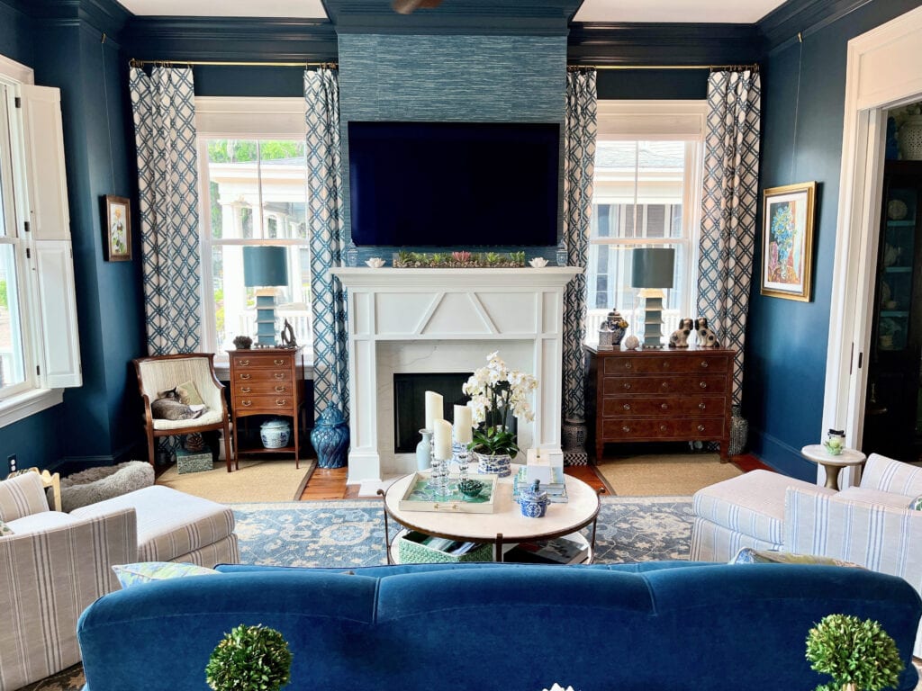 Farrow and BAll Hague blue, dark blue walls, White Dove fireplace, grass cloth look wallpaper, white and blue drapes, traditional room and home decor, marble surround