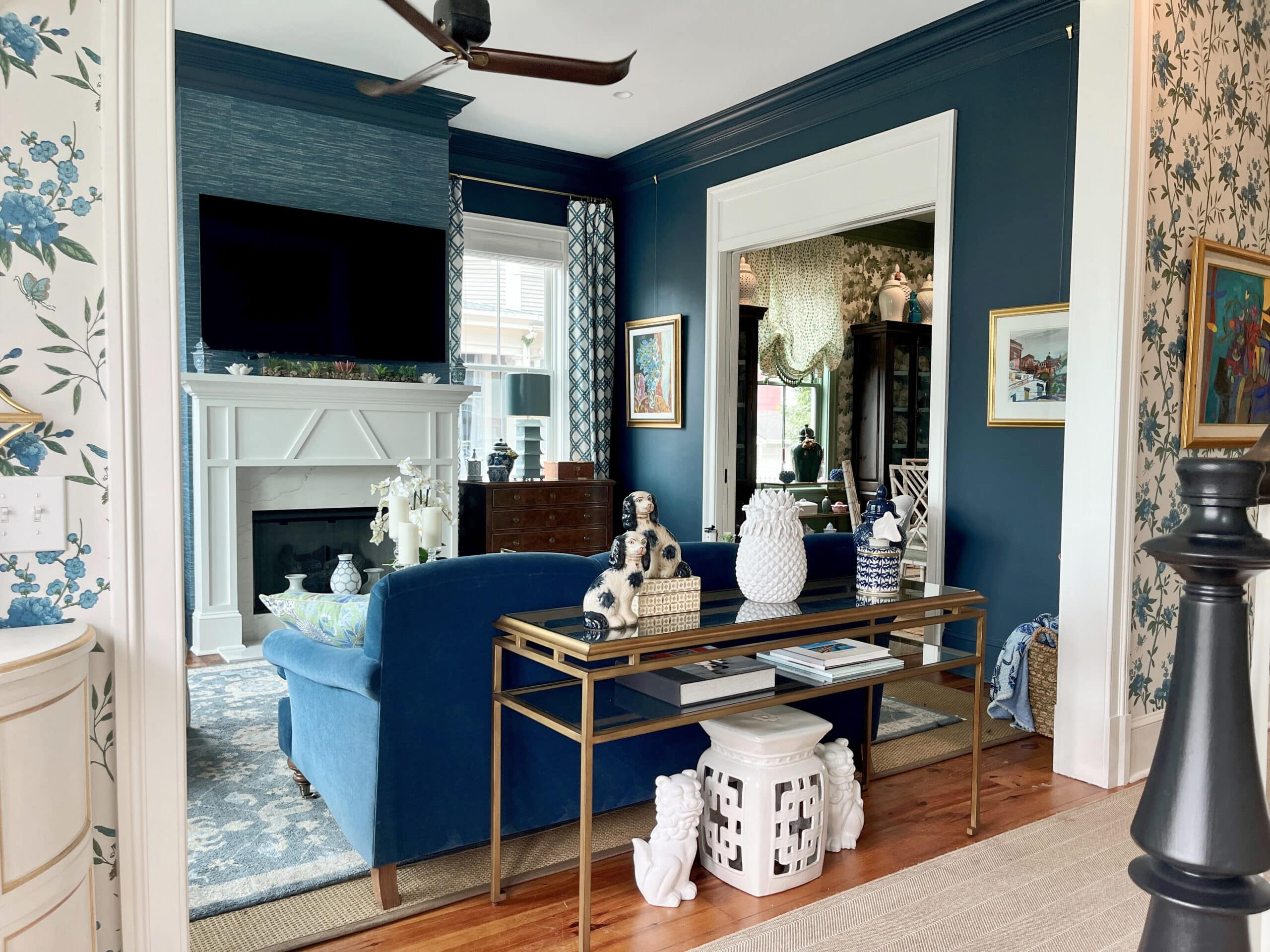 Formal living room in Farrow and Ball Hague Blue with textured grass cloth look wallpaper, blue sofa, Benjamin Moore White Dove trim, traditional home decor