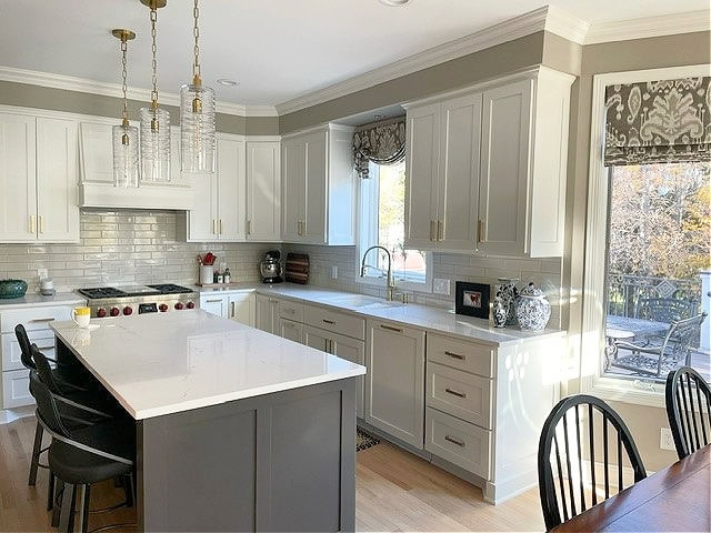 Kitchen cabinets painted Sherwin Williams Cotton, island Urbane Bronze greige, white quartz, greige taupe subway tile, gold hardware, Benjamin Moore Pashmina walls, oak floor (1)