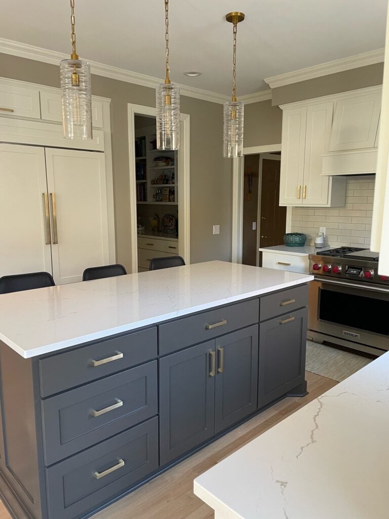 Kitchen with warm white painted cabinets, Sherwin Williams Cotton, Urbane Bronze island, white quartz countertops, wood floor pink undertones, Benjamin Moore Pashmina