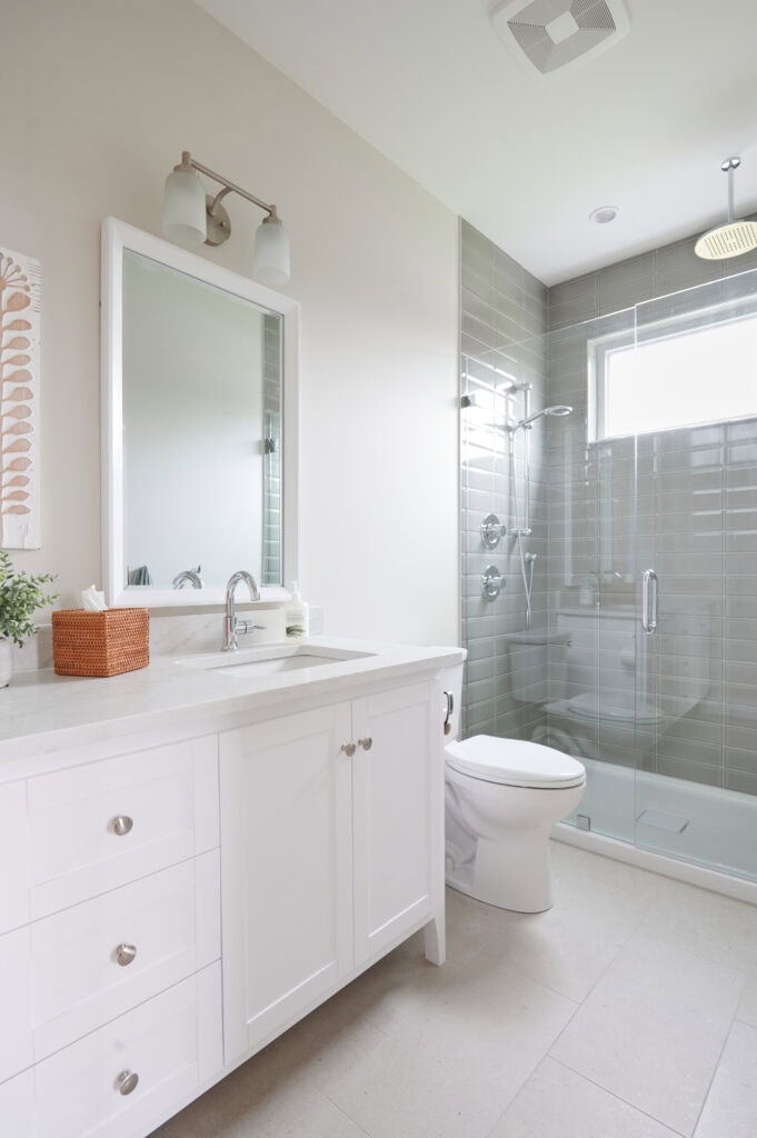 Sherwin Williams Aesethetic White, off-white beige paint color on bathroom walls, walk in shower, acrylic base, green-gray subway tile surround, white vanity, Omnia quartz, beige tile