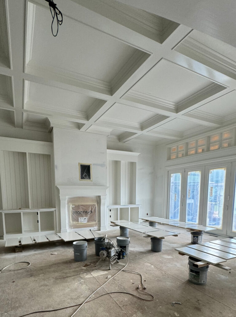 Sherwin Williams Alabaster coffered warm white painted ceiling, white built in cabinets in sides of fireplace, white mantel