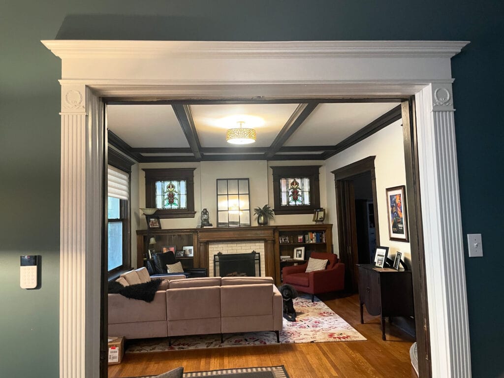Sherwin Williams Creamy living room with dark wood trim and beams, built-ins, oak floor, subway tile fireplace, vintage, older antique home