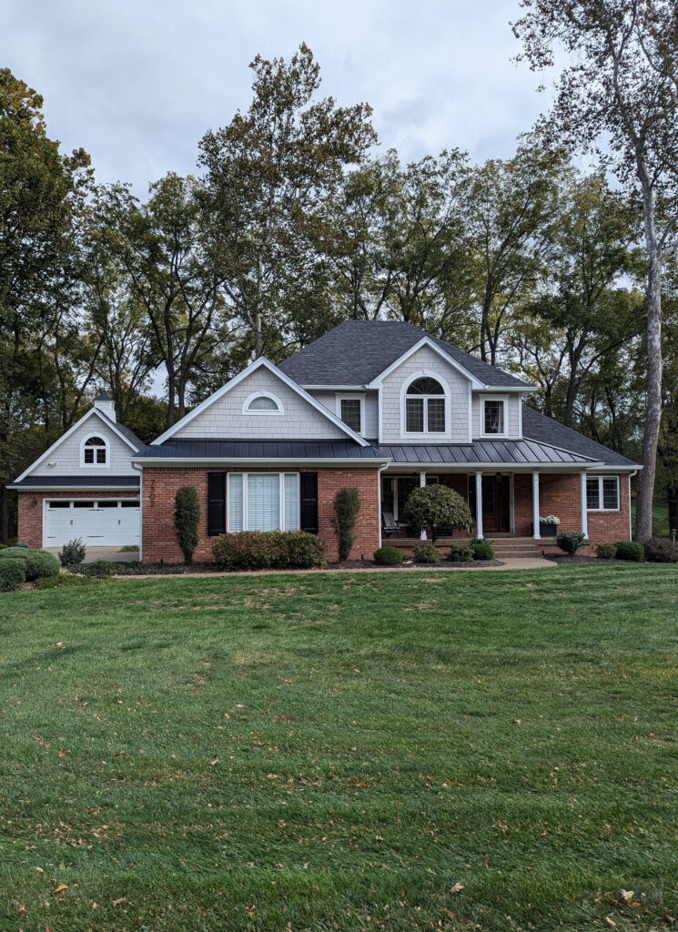 Sherwin Williams LIght French Gray exterior shakes and siding, red orange brick and black shutters, asphalt and metal roof, white trim