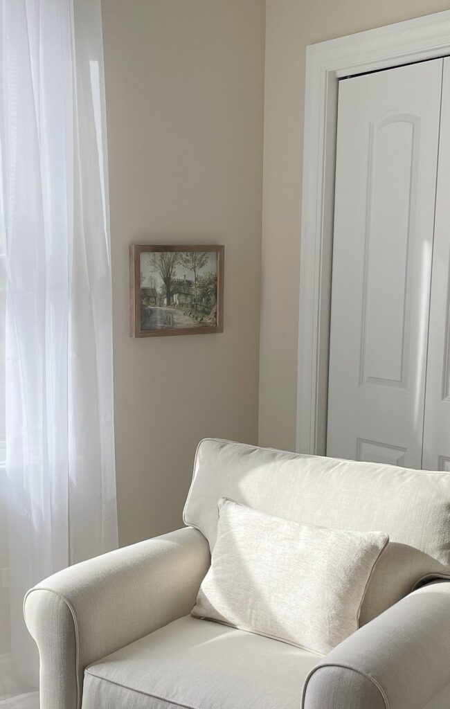 Sherwin Williams Natural Linen in a bedroom with white drape and accent chair