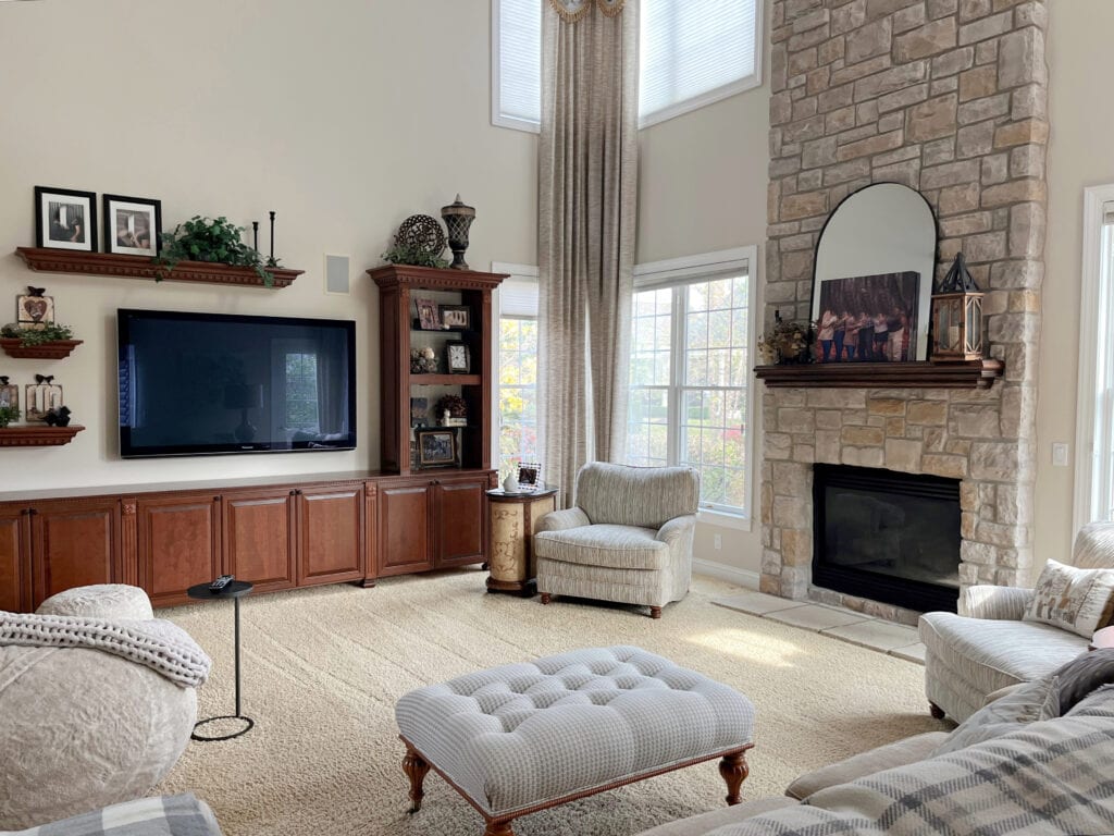 Sherwin Williams Natural Linen, great room, living room vaulted ceiling, stone fireplace, cherry wood maple built ins with tv, beige carpet and drapes, Extra White trim (1)