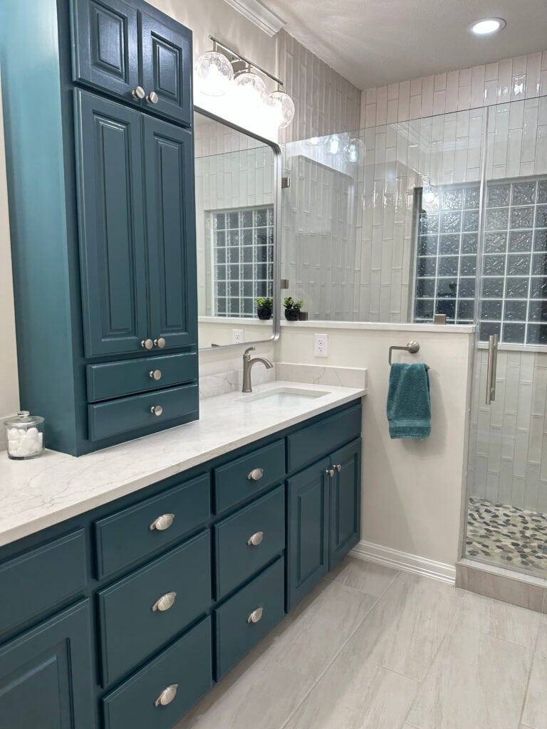 Sherwin Williams Riverway painted oak wood bathroom vanity cabetin, marble look tile floor, off-white quartz countertop, polished nickel hardware