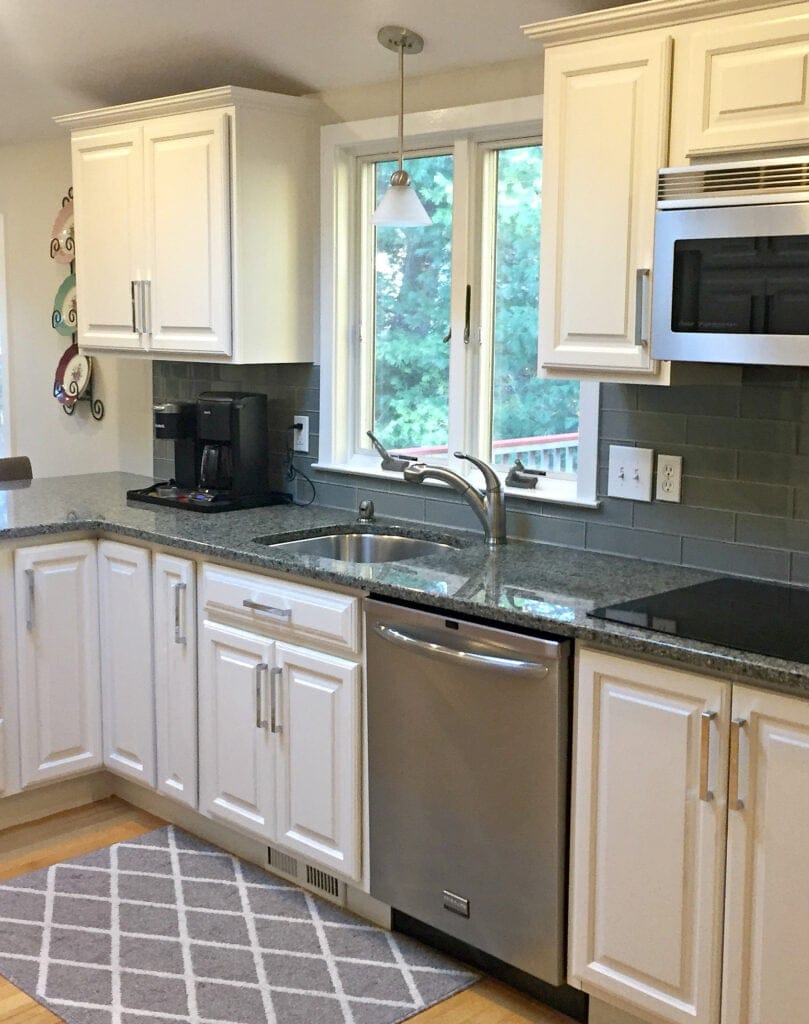 Sherwin Williams White Duck painted maple cabinets and green undertone granite countertop with glass backsplash. Edgecomb Gray walls. Kylie M interiors Edesign