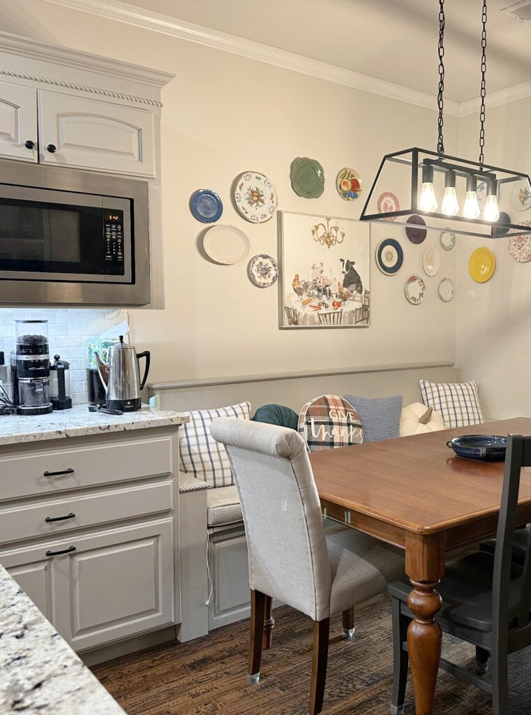 bench, eating nook, wood table, painted cabinets in Benjamin Moore Pashmina Winds Breath warm off-white paint color on walls