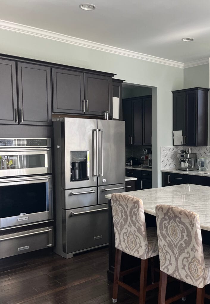 dark espresso wood cabinets and granite countertop, sea salt paint color on walls kitchen