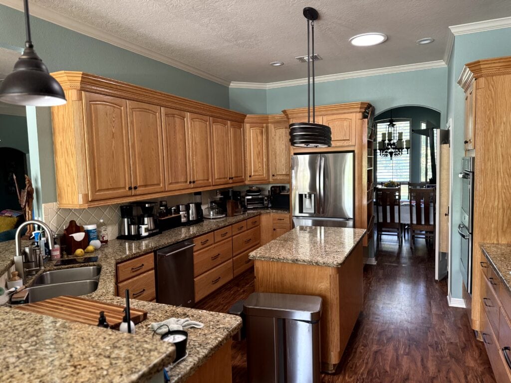 golden oak cabinets, red wood stain floor, santa cecilia or giallo ornamnetal granite countertop, Wythe Blue walls, Moderate White trim is too beige