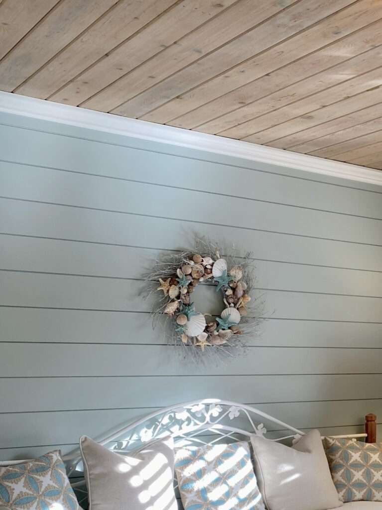 guest bedroom blue-green gray paint color on walls, beige carpet, white trim, wood shiplap tongue and groove ceiling, pink whitewashed undertones, daybed