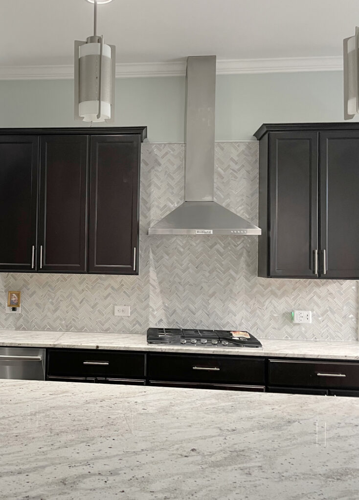 Range hood, wall mount chimney style in stainless, kitchen before with dark espresso wood cabinets and  granite countertops