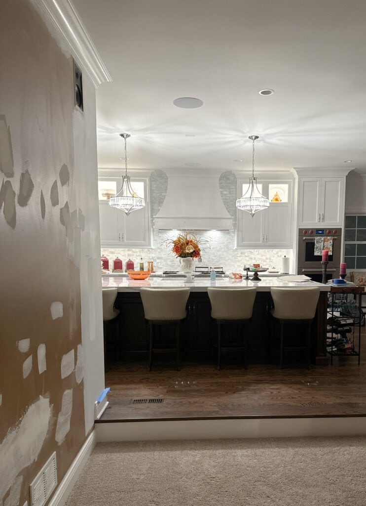 kitchen remodel with white quartz, dark wood stained island, Benjamin Moore Chantilly Lace painted white cabinets with mosaic tile backsplash with coastal colors
