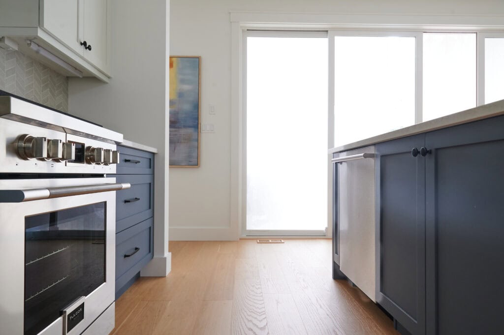 lower cabinets and island painted Benjamin Moore Brittania Blue, best blue color, white oak floor, fulgor range
